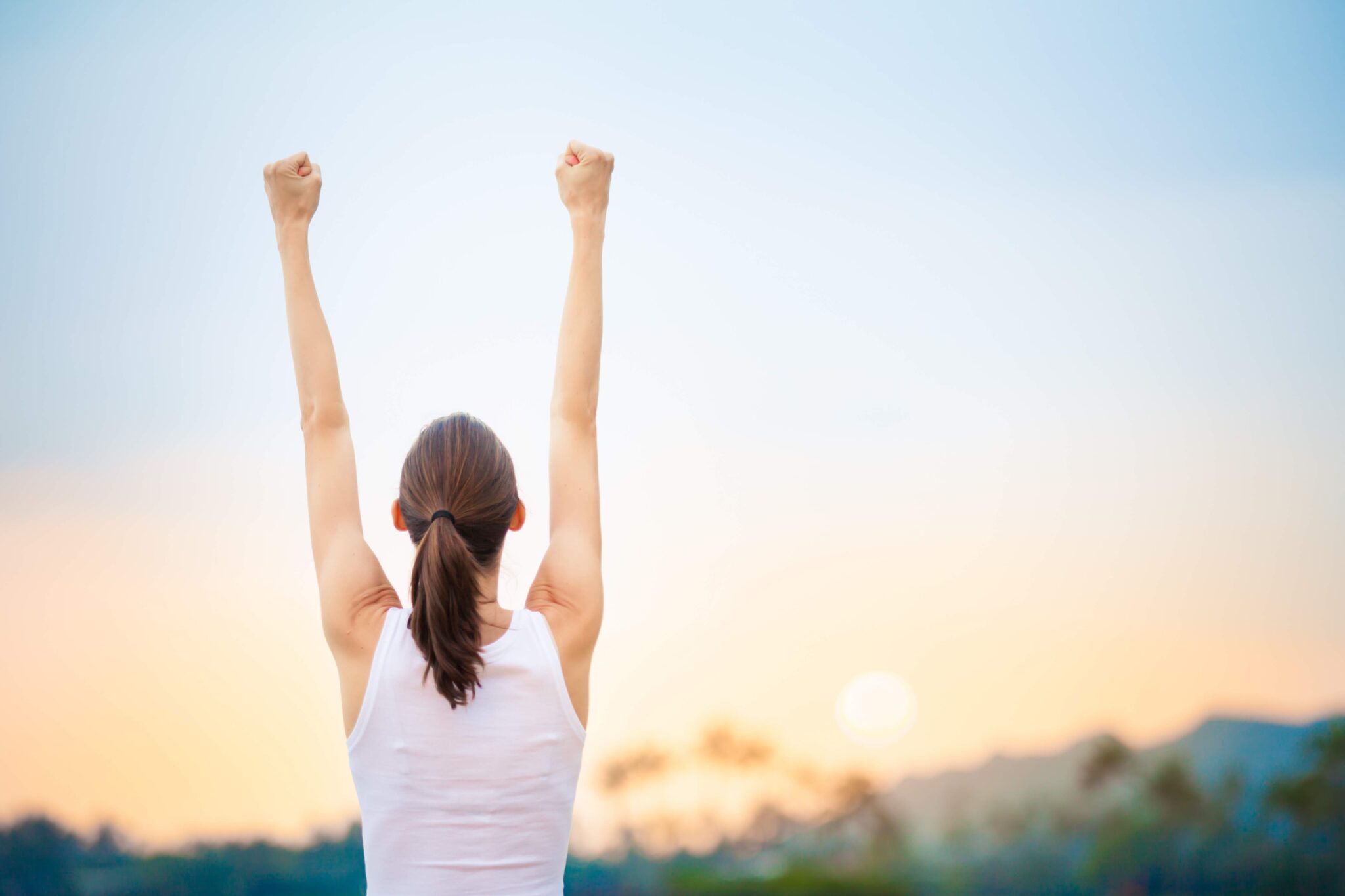 Slim woman fist pumping the air