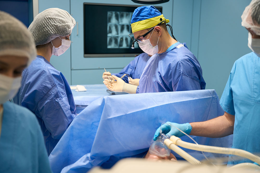 Surgeon performing surgery on a patient